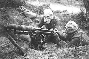 Machine gunners wearing gas masks.